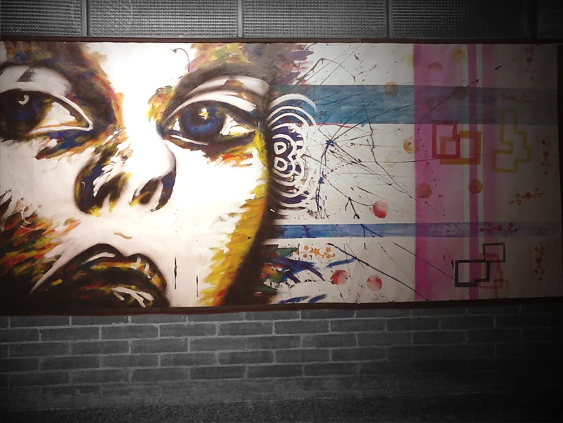 Expressive female portrait mural with graphic patterns and blocks of color